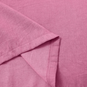 Macro shot of rose pink fabric texture and fine stitching on the sleeveless T-shirt