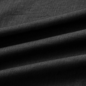 Macro shot of high-quality black plain weave fabric with natural texture and soft drape