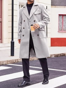 Outdoor shot of men's double-breasted wool coat with lapels and large flap pockets
