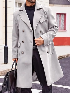 Detail of the double-breasted buttons and flap pocket on this gray wool overcoat