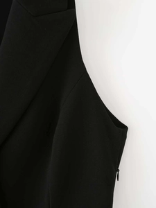 Detailed view of black blazer vest featuring clean lapels and hidden side zipper