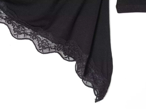 Detail shot of elegant black knit fabric with delicate floral lace trim and stitching