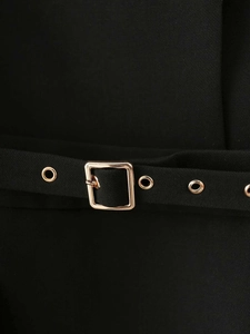 Detailed macro shot of black dress waist belt with golden square buckle and metal eyelets