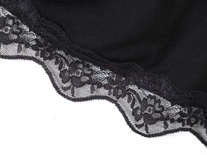 Detail of elegant black floral lace trim on an off-shoulder top with intricate patterns