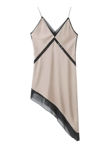 Detail of V-neck satin dress with black lace trim and asymmetric hemline