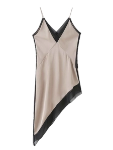 Detail of V-neck champagne satin dress featuring black lace trim and asymmetrical hemline