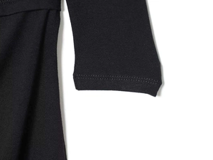 Macro detail of high-quality double-needle stitching on black knitted long sleeve cuffs