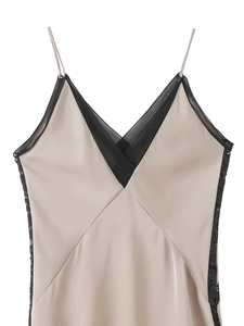 Close-up of champagne satin V-neck dress featuring delicate black lace trim and mesh