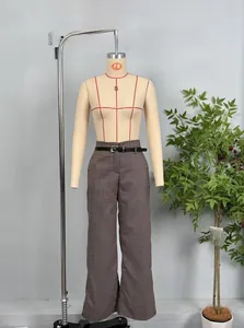 Detail shot of brown houndstooth wide-leg trousers with thin black leather belt