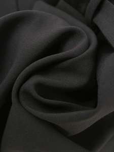 Close-up of black blazer dress fabric showing smooth texture and fine twill weave detail