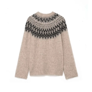 Classic round neck knit sweater with vintage Fair Isle jacquard pattern on beige fabric