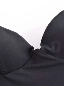 Detailed macro view of the structured cups and ribbed texture on this black satin camisole