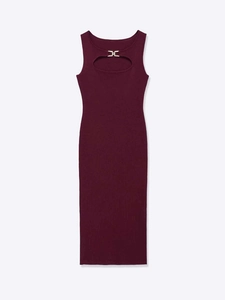 Detail view of burgundy knitted dress featuring a front cutout and gold metal buckle