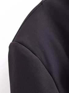 Detail shot of the shoulder seam and woven texture on this black oversized blazer