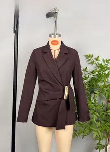 Close-up of brown blazer featuring a cinched waist with gold buckle and tie belt detail