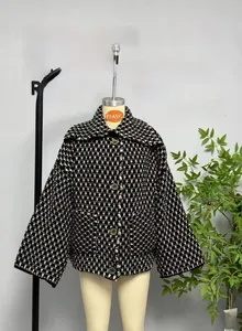 Detail of classic black and white tweed jacket with vintage buttons and lapel collar