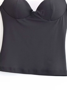 Detailed close-up of a black satin corset top featuring cups and smooth stitching details