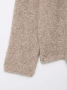 Close-up of soft camel mohair blend fabric showing premium fuzzy knit texture