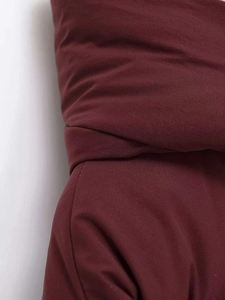 Detailed close-up of burgundy winter hooded jacket showing high-quality fabric texture