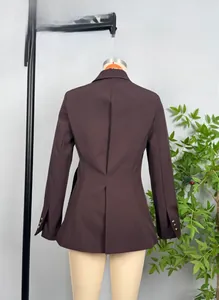 Detail of slim-fit brown blazer back with waist tailoring and gold buttons on cuffs