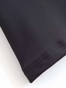 Detail view of smooth black satin top hem with high-quality double-stitch sewing finish