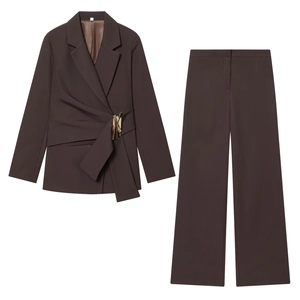 Detailed close-up of dark brown suit jacket with golden buckle and waist pleats