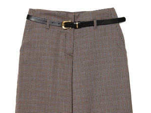 Close-up of vintage houndstooth wide leg trousers featuring a black leather belt with gold buckle
