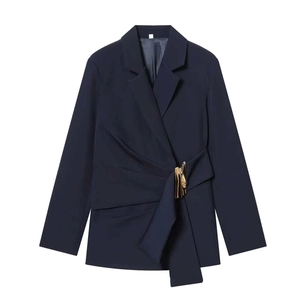 Detailed close-up of navy slim blazer featuring side pleats and a gold metallic buckle