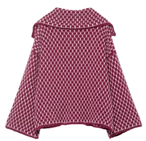 Detail of burgundy and white geometric jacquard knit texture on a wide lapel cardigan
