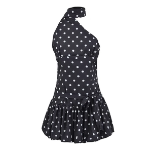 Close-up of black polka dot halter dress featuring a shoulder tie and ruffled hemline