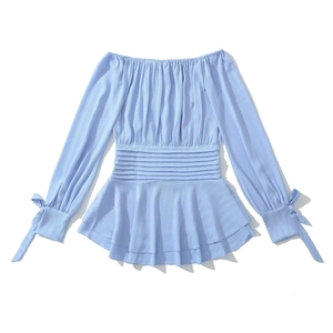 Detail of light blue off-shoulder top with ruffled hem and bow-tied lantern sleeves