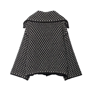 Detail view of the black and white knit cardigan with a stylish oversized collar