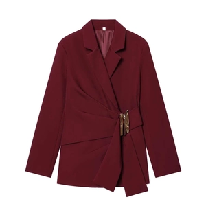 Detail of burgundy wrap blazer with golden buckle and textured fabric