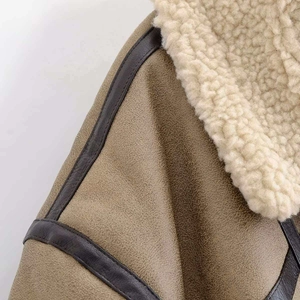 Detailed view of khaki suede jacket with faux shearling lining and dark brown trim