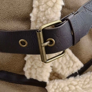 Detail of khaki suede jacket with plush white shearling lining and vintage metal buckle