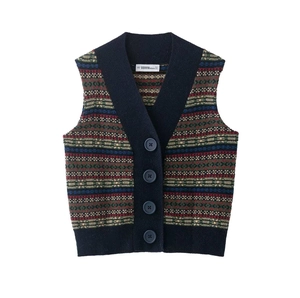 Detail view of vintage V-neck jacquard knitted vest with navy buttons and geometric patterns
