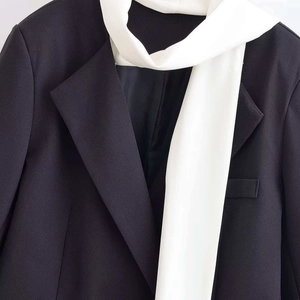 Minimalist black oversized blazer with notched lapel and white decorative scarf for women