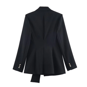 Back view of black blazer showing pleated hem detail and gold sleeve buttons