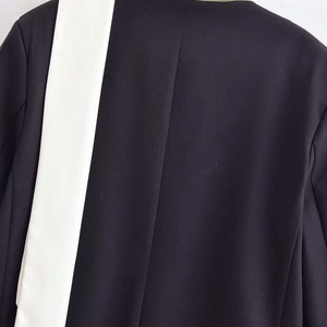 Chic oversized black blazer with a vertical white contrast panel on the back