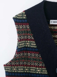 Close-up of retro geometric jacquard pattern on navy blue V-neck knit vest