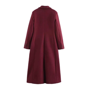 Detail view of burgundy wool coat back featuring classic seams and sleeve button accents