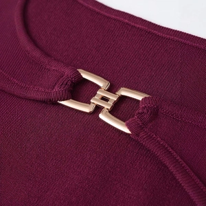 Chic burgundy ribbed knit dress with an elegant gold interlocking buckle at the neckline