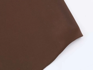Close-up of dark brown draped halter top fabric showing precise stitching and woven texture