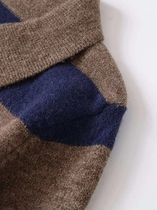 Close-up of high-quality striped knit fabric texture with detailed wool blend stitching