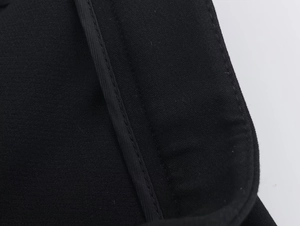 Close-up of the professional stitching and hem details on the black blazer fabric