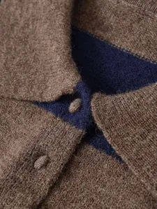 Macro detail of the contrast striped knit fabric and matching fabric-covered buttons