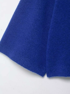 Close-up detail of high-quality blue knit fabric texture on a minimalist turtleneck sweater