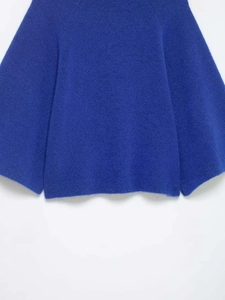 Detail of royal blue knit sweater showing wide bell sleeves and fuzzy mohair texture