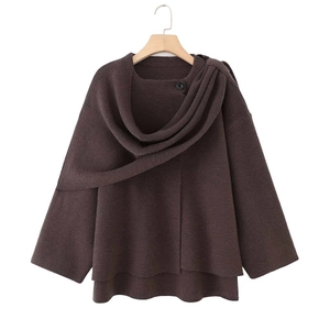 Detail view of deep chocolate brown knitted cape with layered collar and button detail