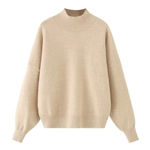Detail view of beige loose-fit knit sweater with ribbed mock neck and dropped shoulders